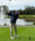 picture of a golfer swinging at tee
