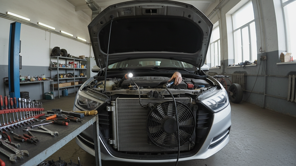 Wide-angle view of a radiator and cooling fan being inspected in a workshop