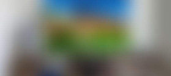 Living room setup with a TV showing PlayStation 5 and PS5 Pro, a PSVR headset, and DualSense controllers on a table.