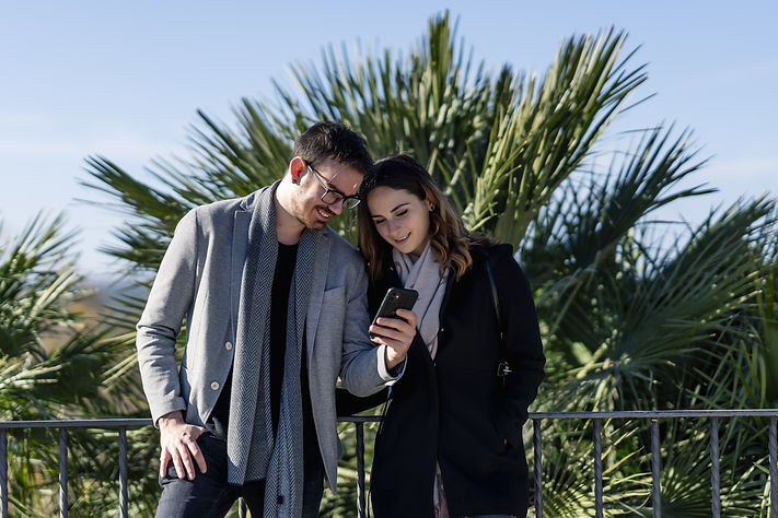 closeup-shot-woman-young-man-looking-mobile-phone.jpg