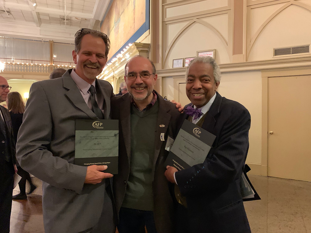 Ray, recipient of the Outstanding Philanthropic Citizenship Award, poses with Steve Fuller of 94 HJY and Pete Cardi