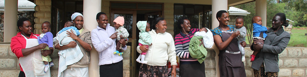 women holding babies