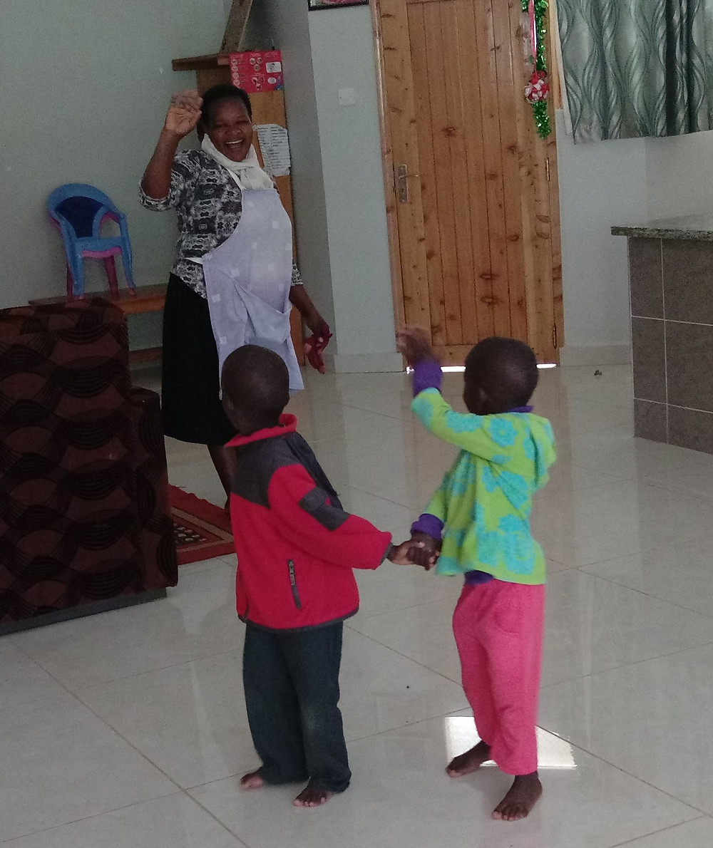 Twins waving goodbye to mom