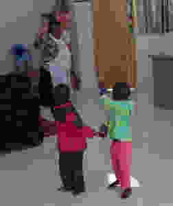 Twins waving goodbye to mom