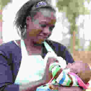 Woman bottle-feeding baby