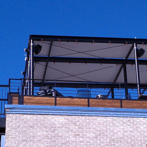 "Residential steel pergola with solar shade material, providing UV protection and a stylish upgrade to outdoor spaces