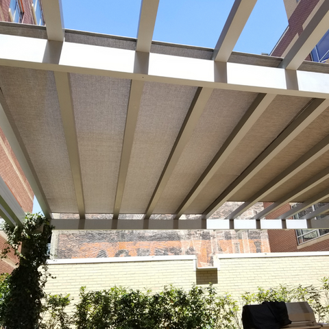 Pergola enhanced with solar fabric, blocking UV rays while maintaining a sleek and modern design