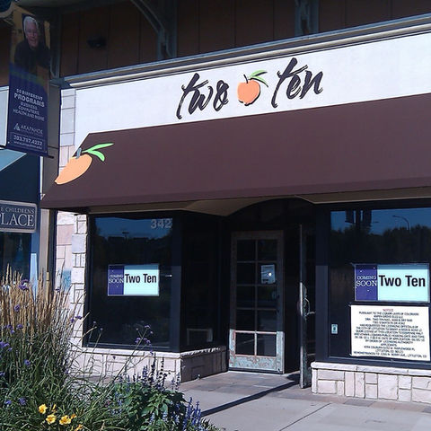 Custom graphics on a fabric awning, showcasing a business logo and branding for a storefront in Denver, Colorado