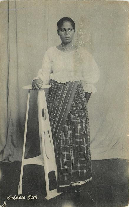 A black and white photograph of a single ayah standing and staring into the camera lense.