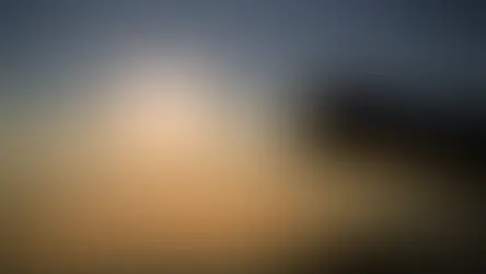 Silhouette of a hand holding an open Bible with a cross pendant at sunrise, symbolizing spiritual awakening and the Charism Gifts described in the book of Isaiah.