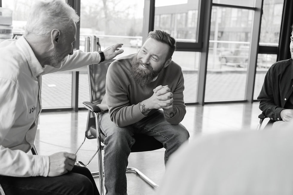 Mature man comforting smiling person with alcohol addiction in rehab center_edited.jpg