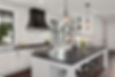 Beautiful Kitchen in New Luxury Home. Features Black Counters and Island, with White Woodw