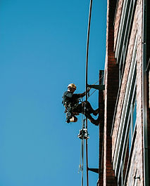 A man on a high wire working on a building_edited.jpg