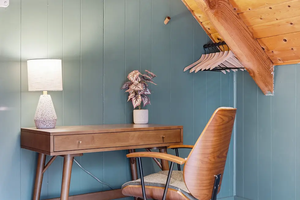 Modern home office workspace with wooden desk and shiplap wall in Poconos home rental