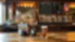 Warm wood-paneled interior of a bars Whitefish MT tap room with rows of draft handles and whiskey shelf glow