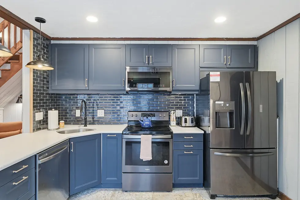 Modern kitchen with blue cabinetry and subway tile at vacation rental near Pocono Mountains skiing Long Pond PA