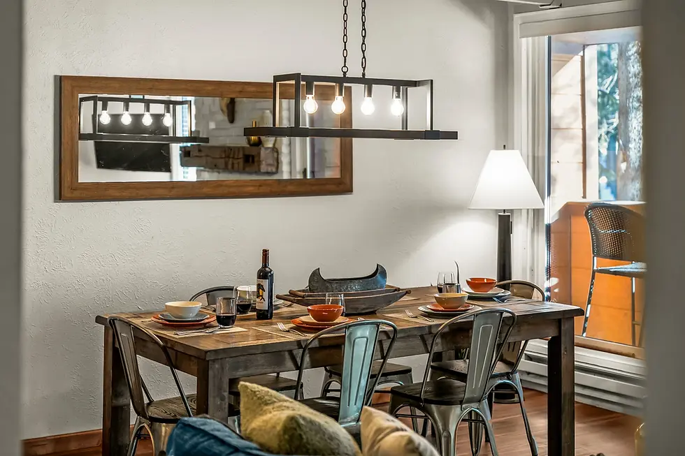 Modern dining room with rustic wooden table and industrial chairs in Breckenridge holiday rental mountain home with large