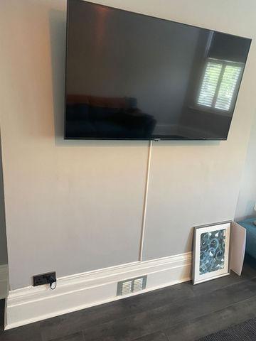 Painting a living room wall as well as sourcing and hanging a flat screen TV bracket. 
I also tidied up the cables with some slim line trunking.
