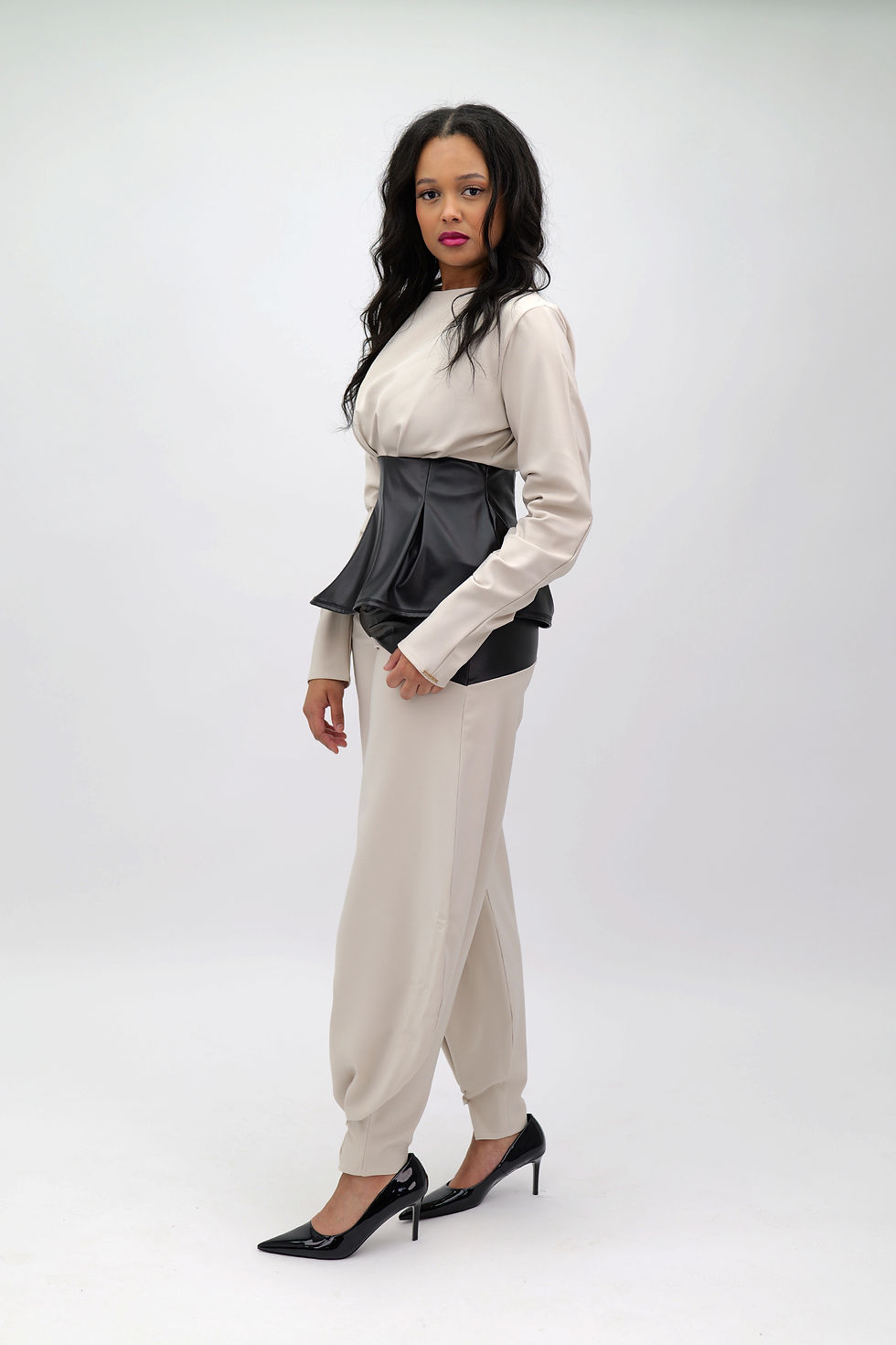 الصورة المصغرة: Women’s  taupe co-ord with sculpted black faux-leather peplum top and wide-leg trousers with pearl tapered cuffs | Millenia