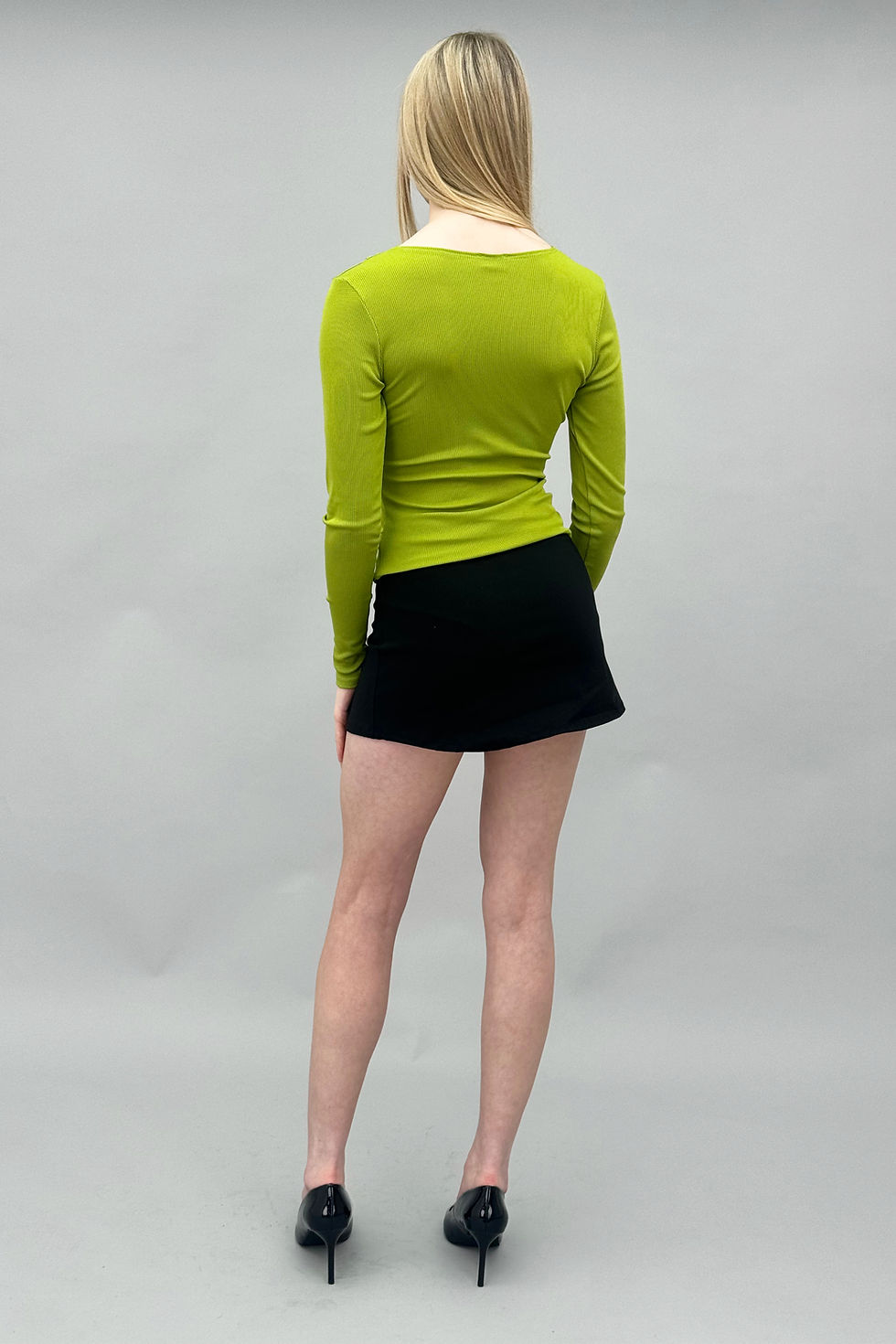 Thumbnail: Lime green ribbed long-sleeve top with a boat neckline & asymmetric line of circular cut-out details down the front and side