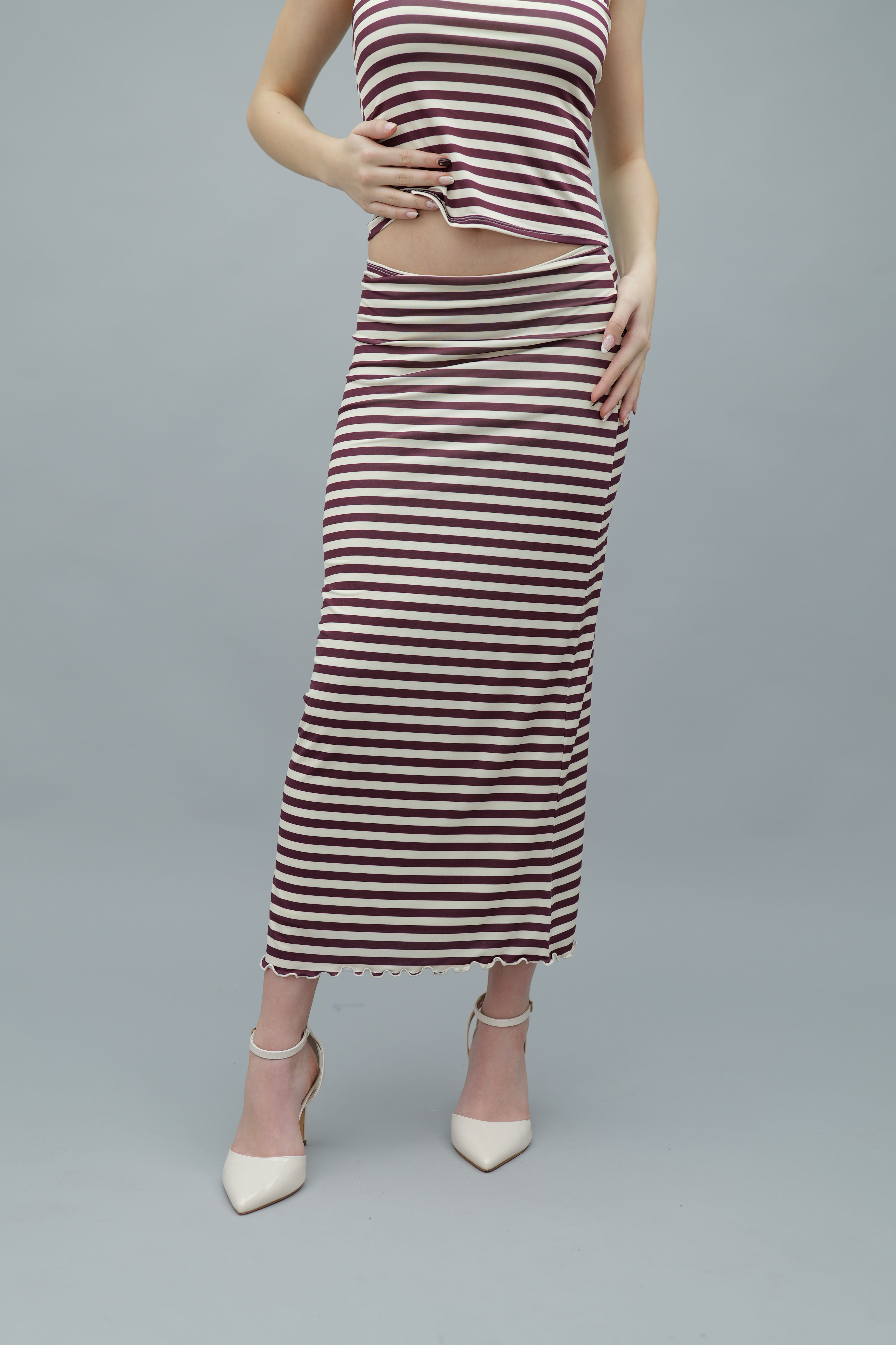 Burgundy and white striped high-waisted midi skirt with a bodycon fit and a wavy lettuce hem