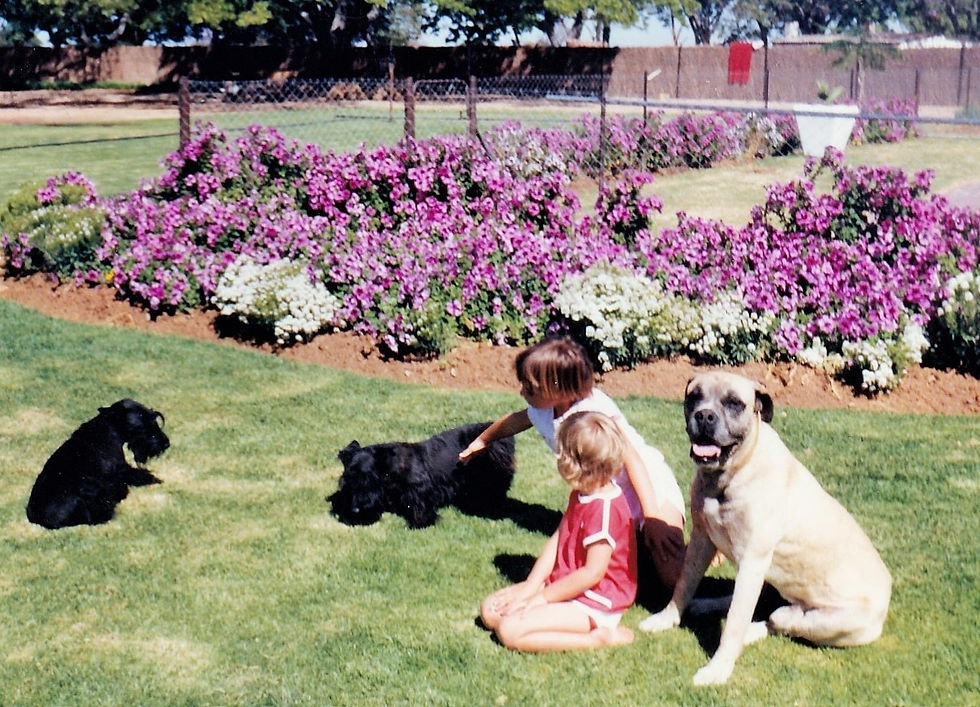 Janine and Storm in our garden on Diandra with the Scotties and Killer who loved the kids