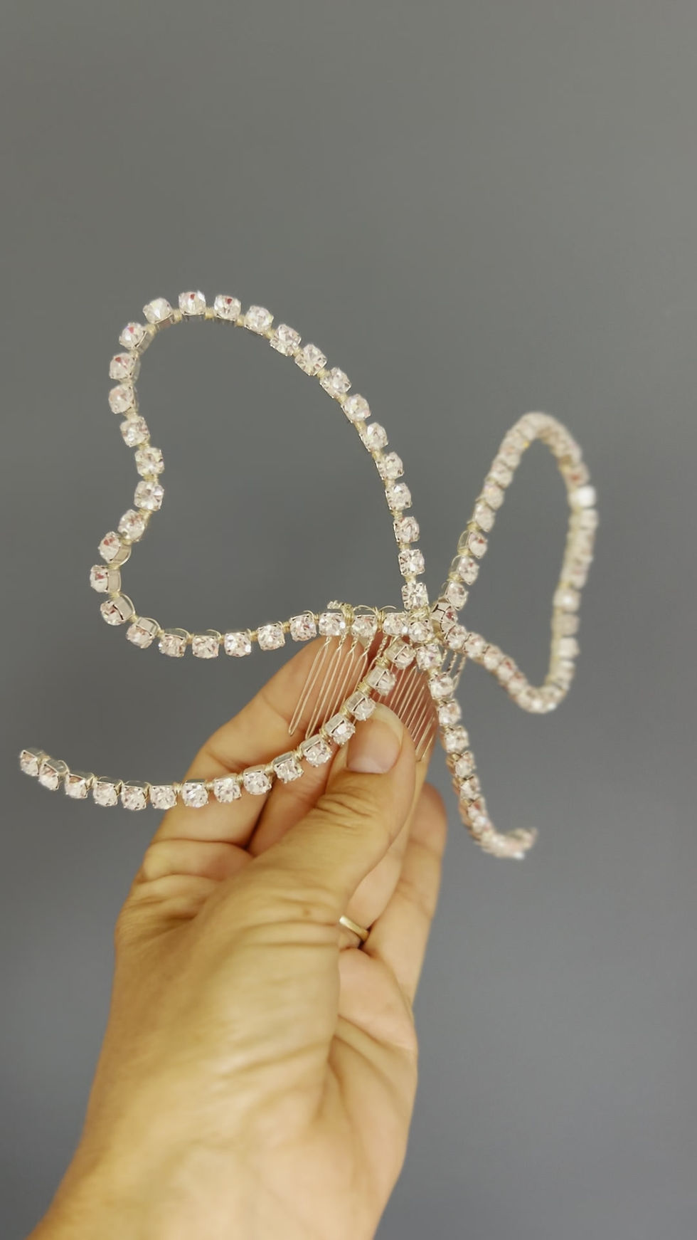 Thumbnail: Video of an extra large crystal bow set on a silver comb for accessorising wedding and bridal hairstyles