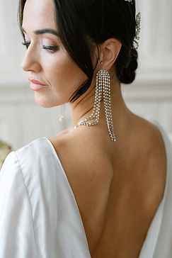 Brunette bride accessorise her look with dramatic long crystal diamanté earrings