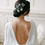 Thumbnail: Romantic silver and ivory flower hair pins for bride and weddings modelled in a bun bridal hairstyle