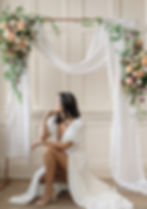 Brunette bride wears hair down in loose waves accessorised with a geometric black and clear crystal wedding headband