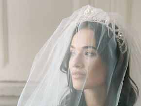 Brunette bride modelling the ZARA silver and pearl crown from NEW ROMANTICS a collection of wedding hair accessories from designer Glorious by Heidi