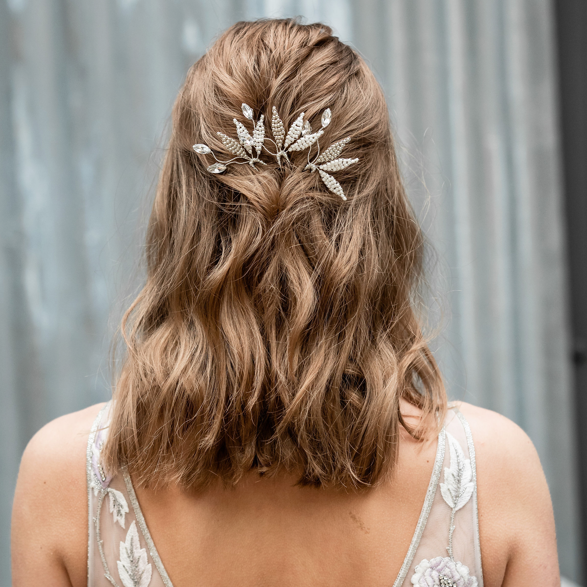 silver and ivory leaves, crystal bridal hair pins styled in dark blonde waved hair