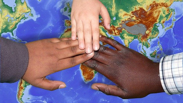 Children of different races touching hands. We were all made in the image of God.