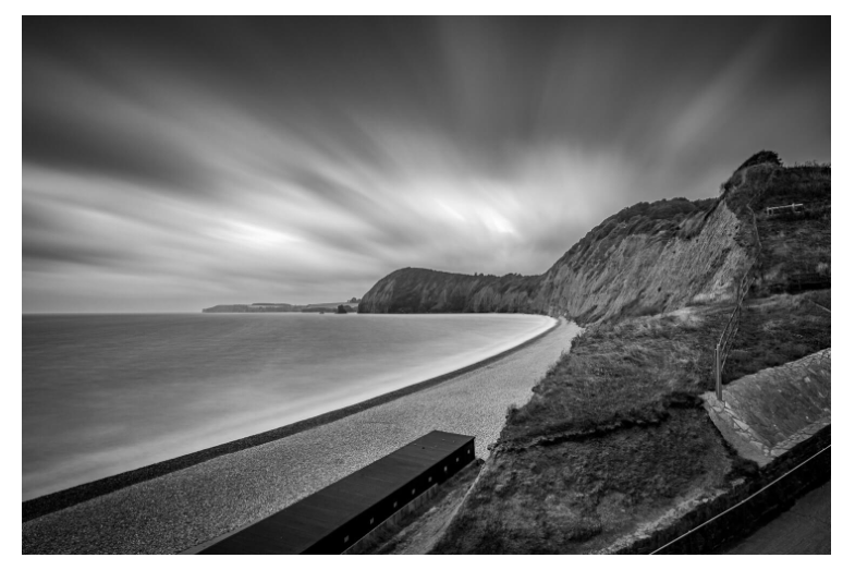A long exposure black and white photo of Jacob's Ladder beach, Sidmouth