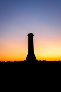 A silhouette of the Hardy Monument, Dorset, at dawn by Dorset Photographer Gary Holpin Photography