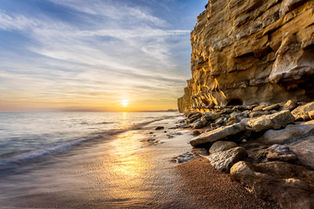 The setting sun lights up the golden coloured cliffs of Hive beach on the Dorset Jurassic Coast, by Dorset photographer, Gary Holpin Photography