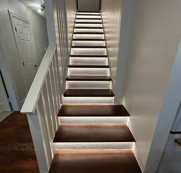 Interior staircase renovation with wood steps and white walls