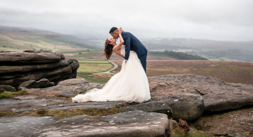 A breathtaking moment captured by Liva Paseka Photography, showcasing a passionate kiss between the bride and groom at Peak District