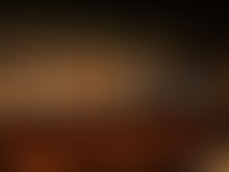 Glowing bar at Tago Houston with warm lighting, bottle display, and moody lounge atmosphere