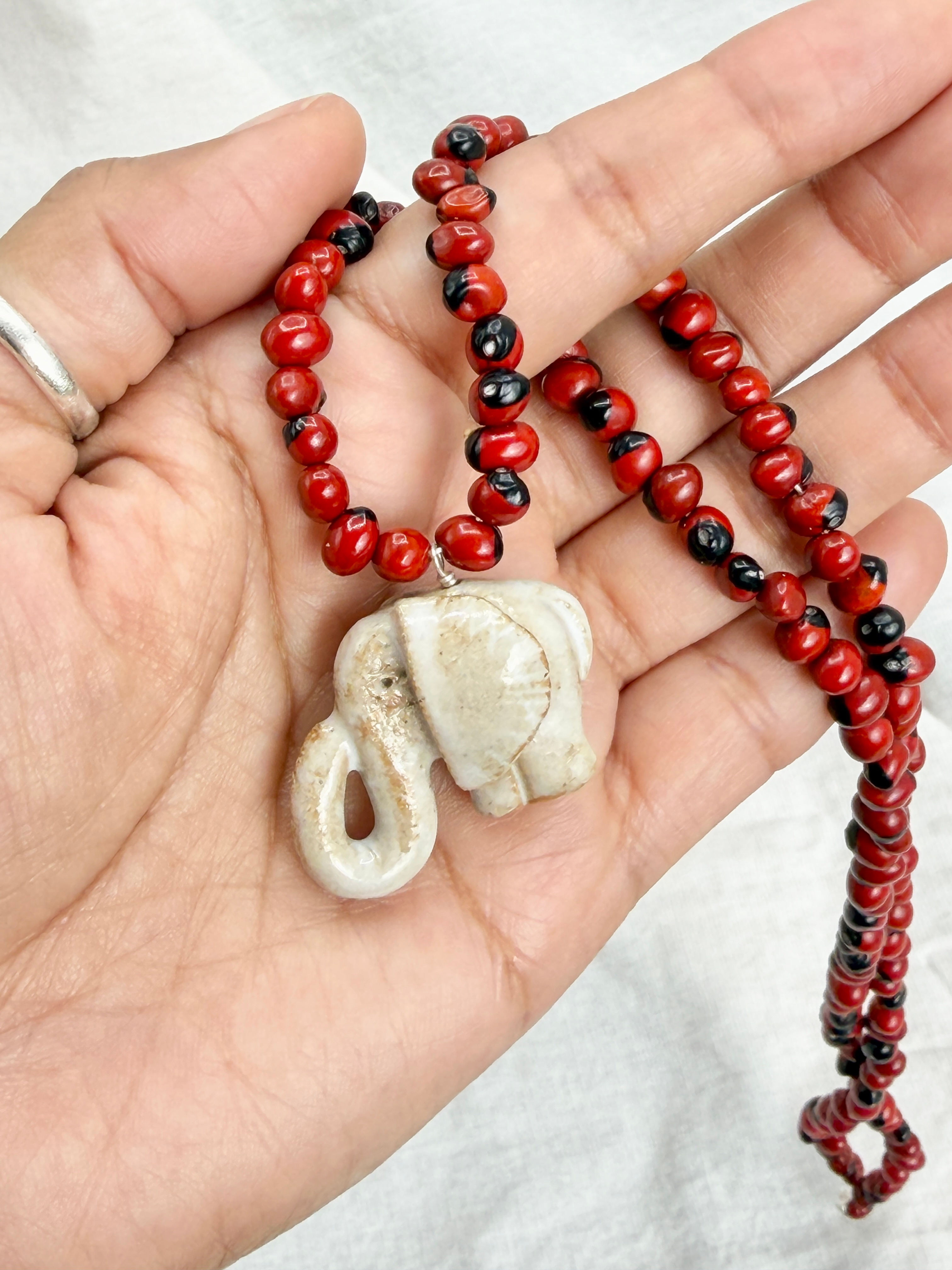 Wayruro Seed Necklace with White Ceramic Elephant