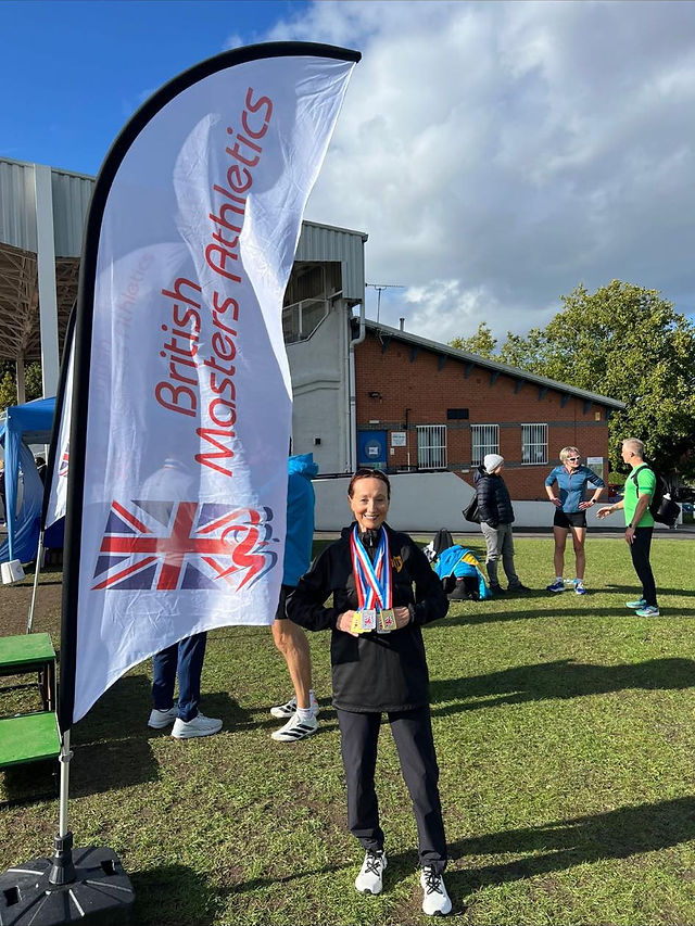 Doreen Craig with her medals next to the BMAF flag