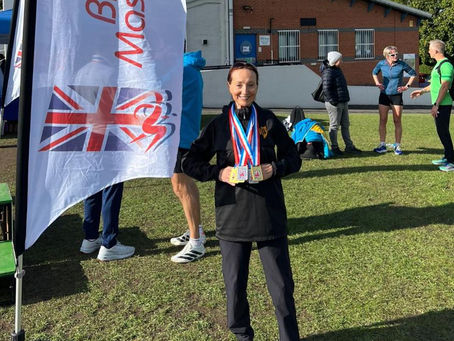 Doreen Craig with her medals next to the BMAF flag