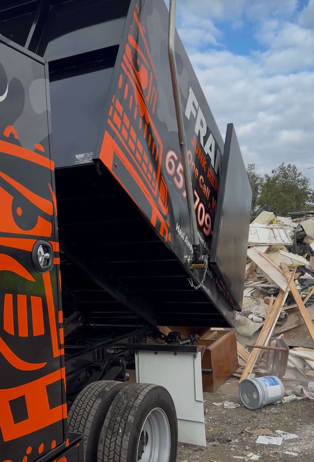 Frank's Junk Removal's dump truck in action at a transfer station in Orange County.