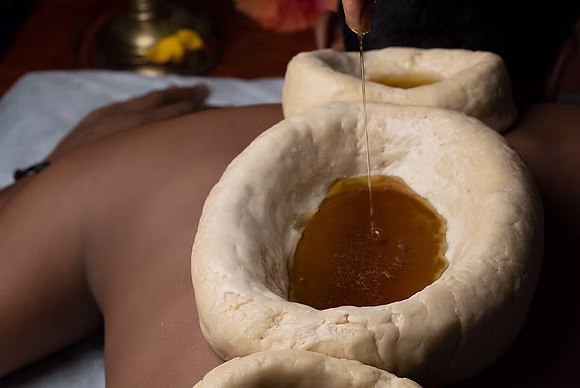 Ayurvedic oil therapy on the neck – natural treatment for stiffness and pain relief in Katy TX.