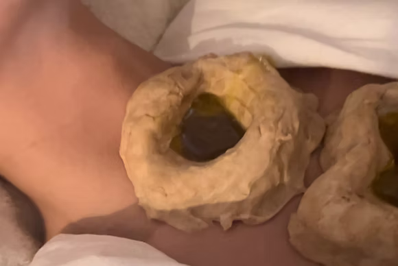 Ayurvedic oil therapy on the throat – natural treatment for wellness and hormonal balance.