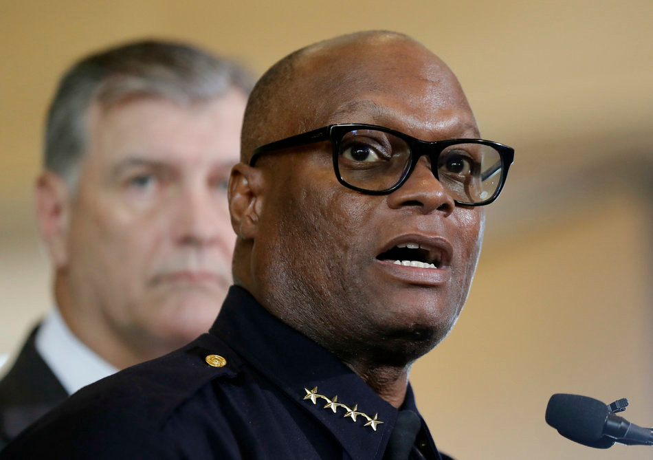 Dallas police Chief David Brown, front, and Dallas Mayor Mike Rawlings, talk with the media during a news conference Friday. (Eric Gay/AP)