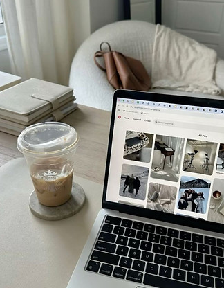 Laptop with coffee, notepad, and chair