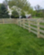 Wooden privacy and farm fence solutions for a lush lawn.