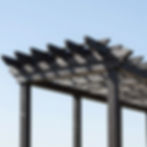 Modern dark wood pergola with lattice roof detail.