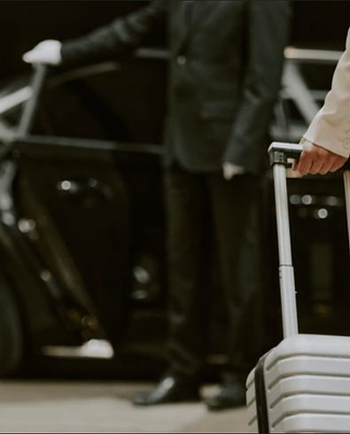 Women with suitcase entering vehicle